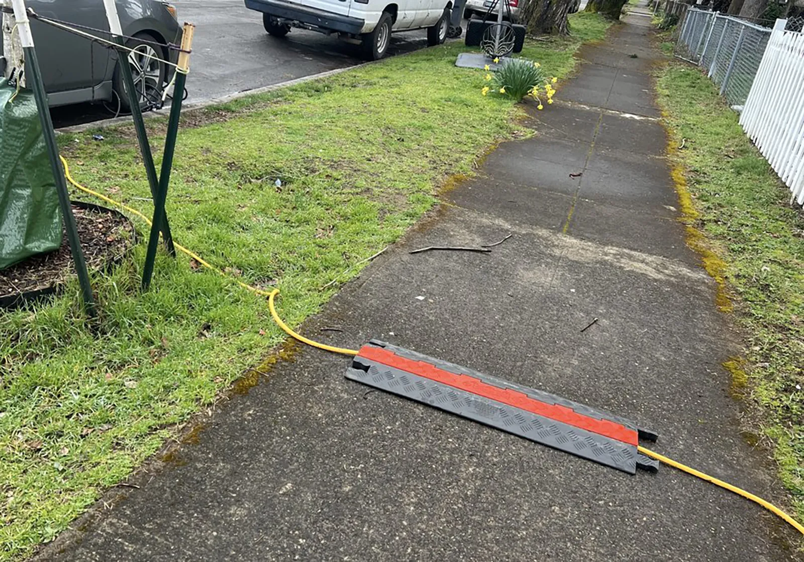 a cord being covered on a side walk